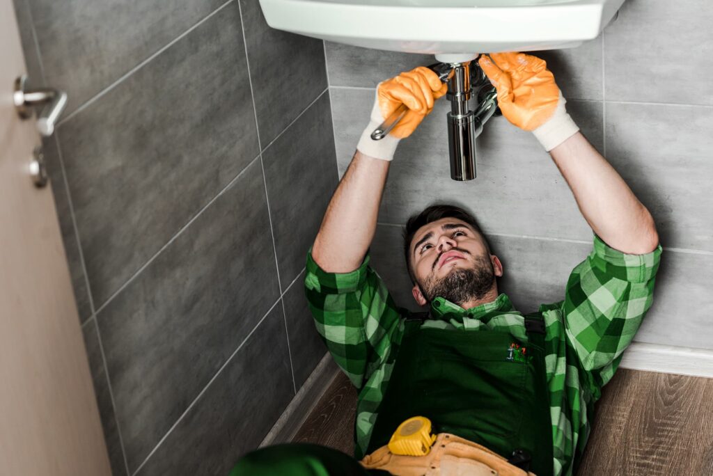 plumber working on sink